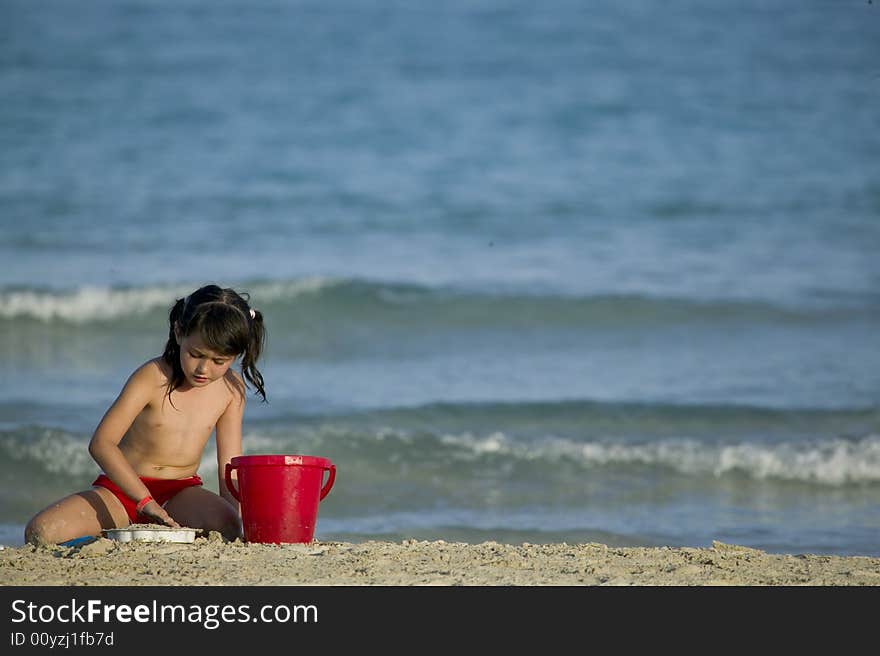 Little child play with sand