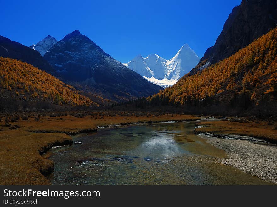 Plateau snow-capped mountains with river, in the yading scenic scenic spots, daochen ,china. Plateau snow-capped mountains with river, in the yading scenic scenic spots, daochen ,china