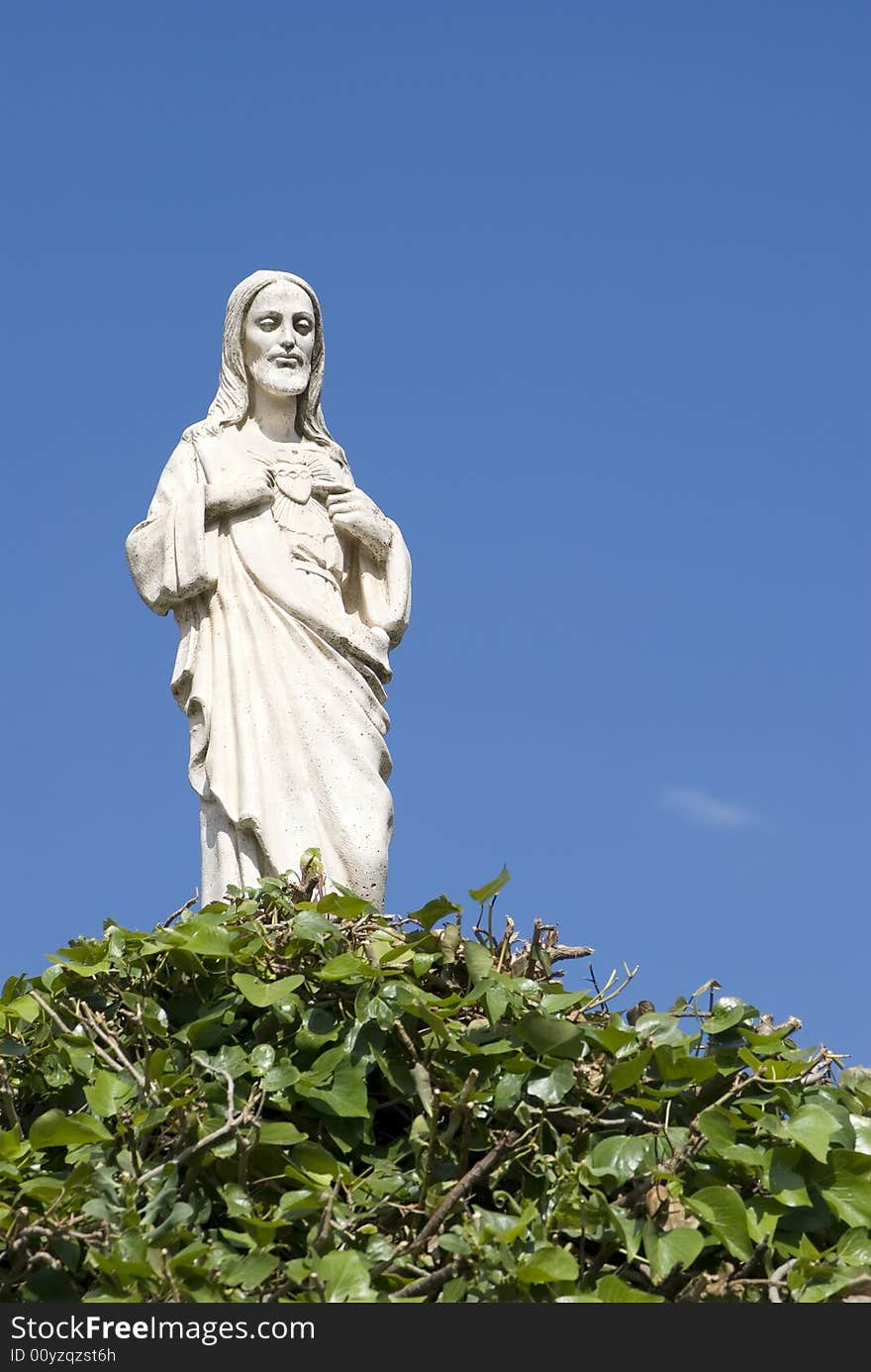 Jesus's white statue on a background of the blue sky