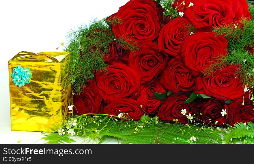 Red roses with a gift on a whiteness