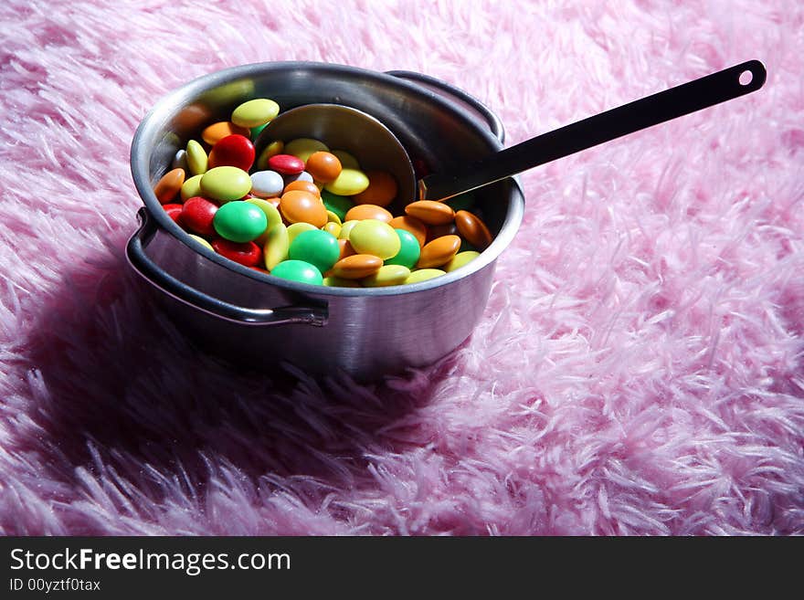 Many colored candies on a carpet