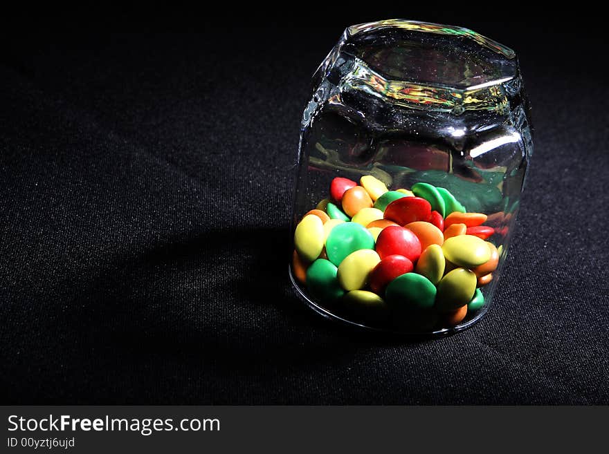 Many colored candies in a glass