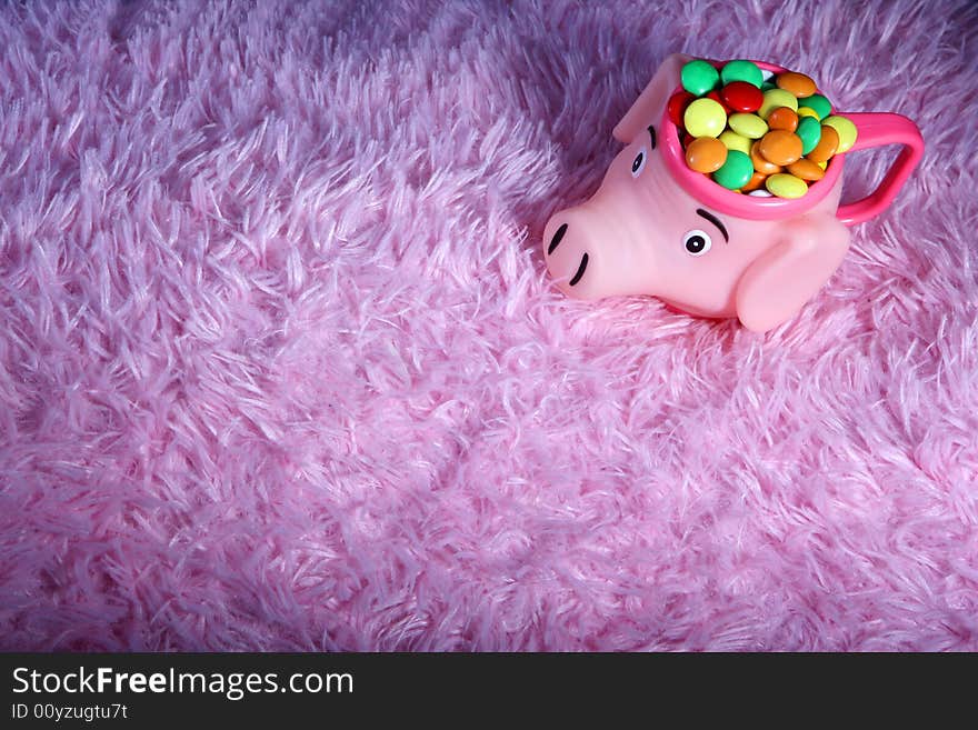 Many colored candies and a piggy bank