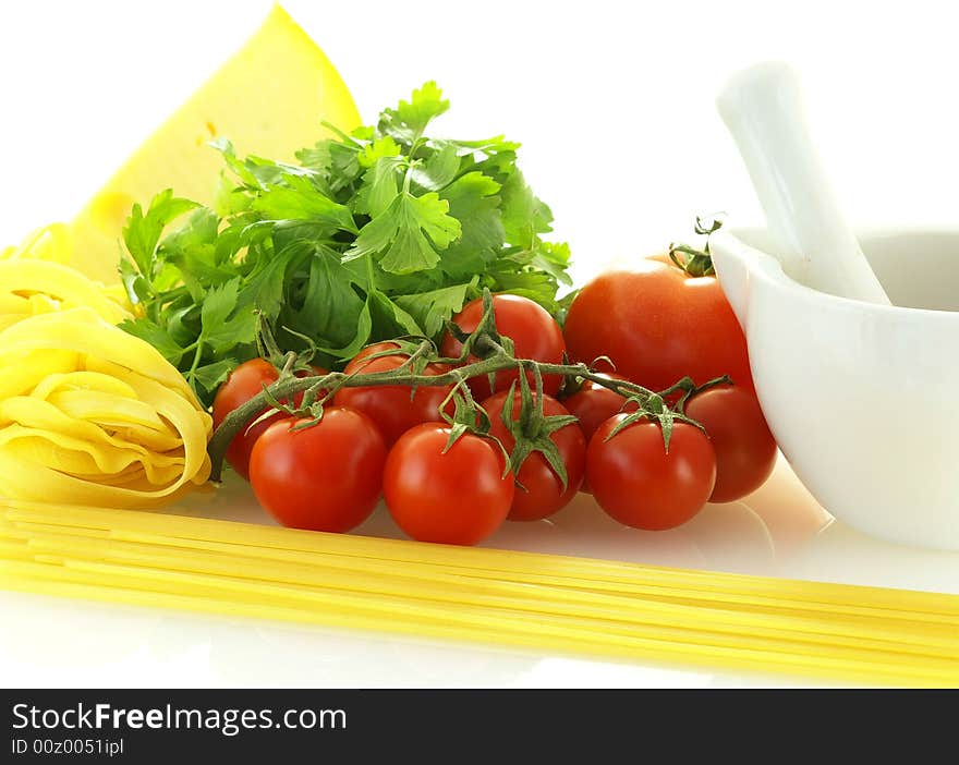 Fresh ripe tomatoes with parsley, cheese and pasta over white background