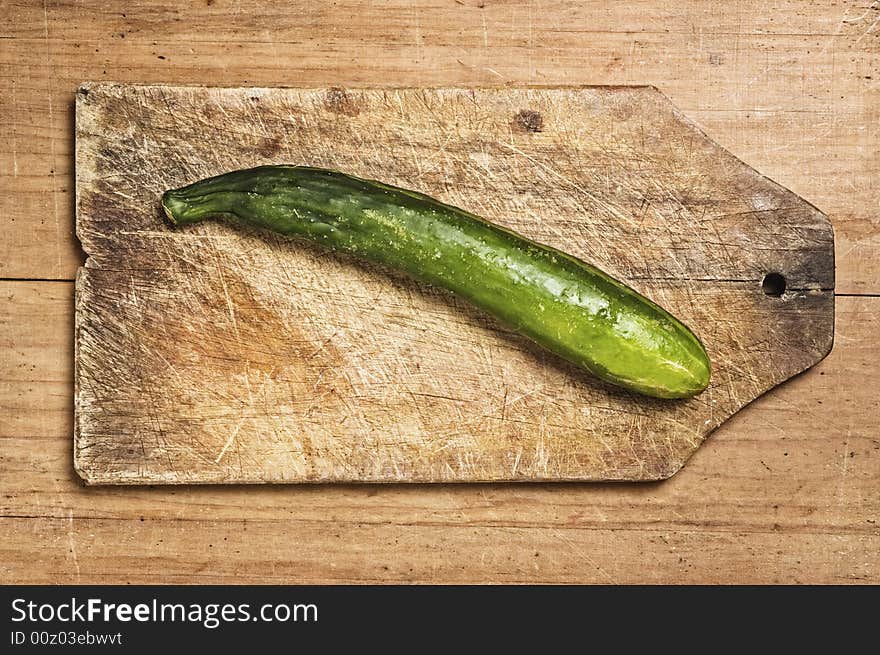 Fresh ucumber on cutting table, studio shot. Fresh ucumber on cutting table, studio shot.