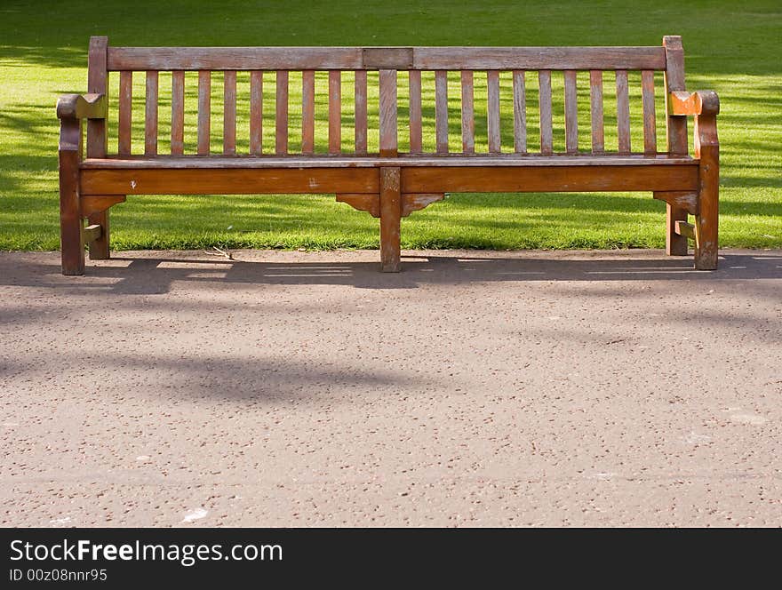 Wooden bench in edinburgh park, alone