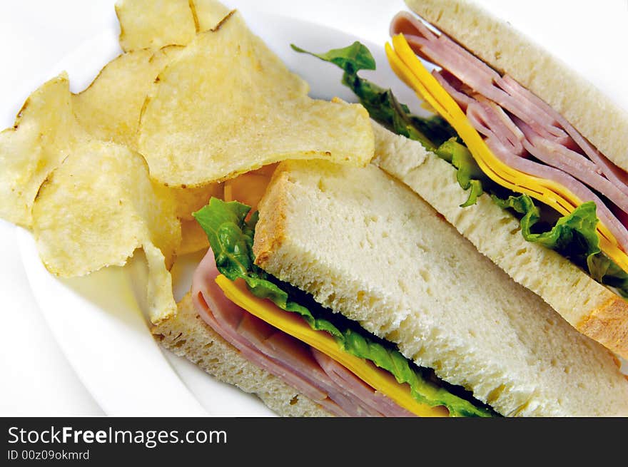 Ham and Cheese Sandwich with potato chips on white background. Ham and Cheese Sandwich with potato chips on white background.