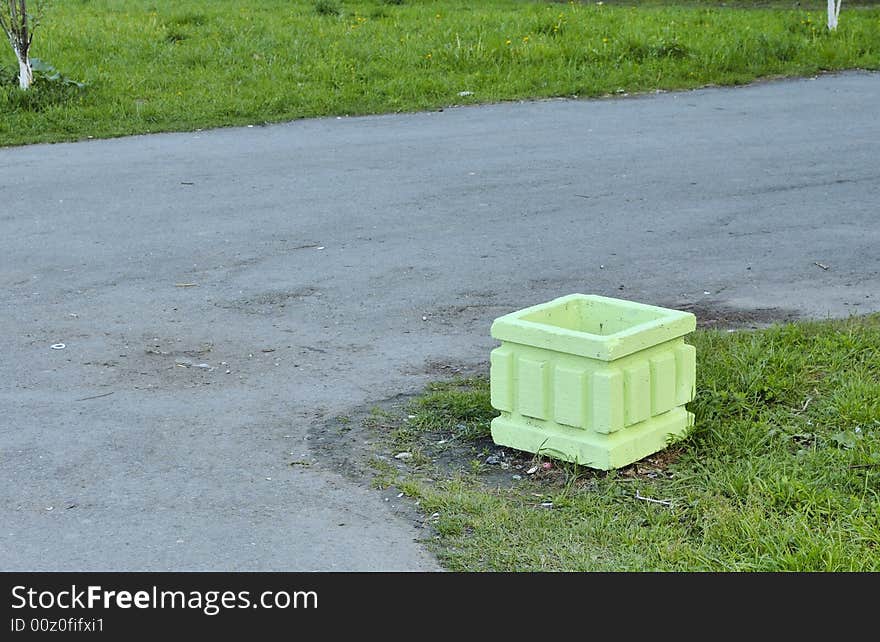 Photo of asphalt pavement and refuse bin colored light-green