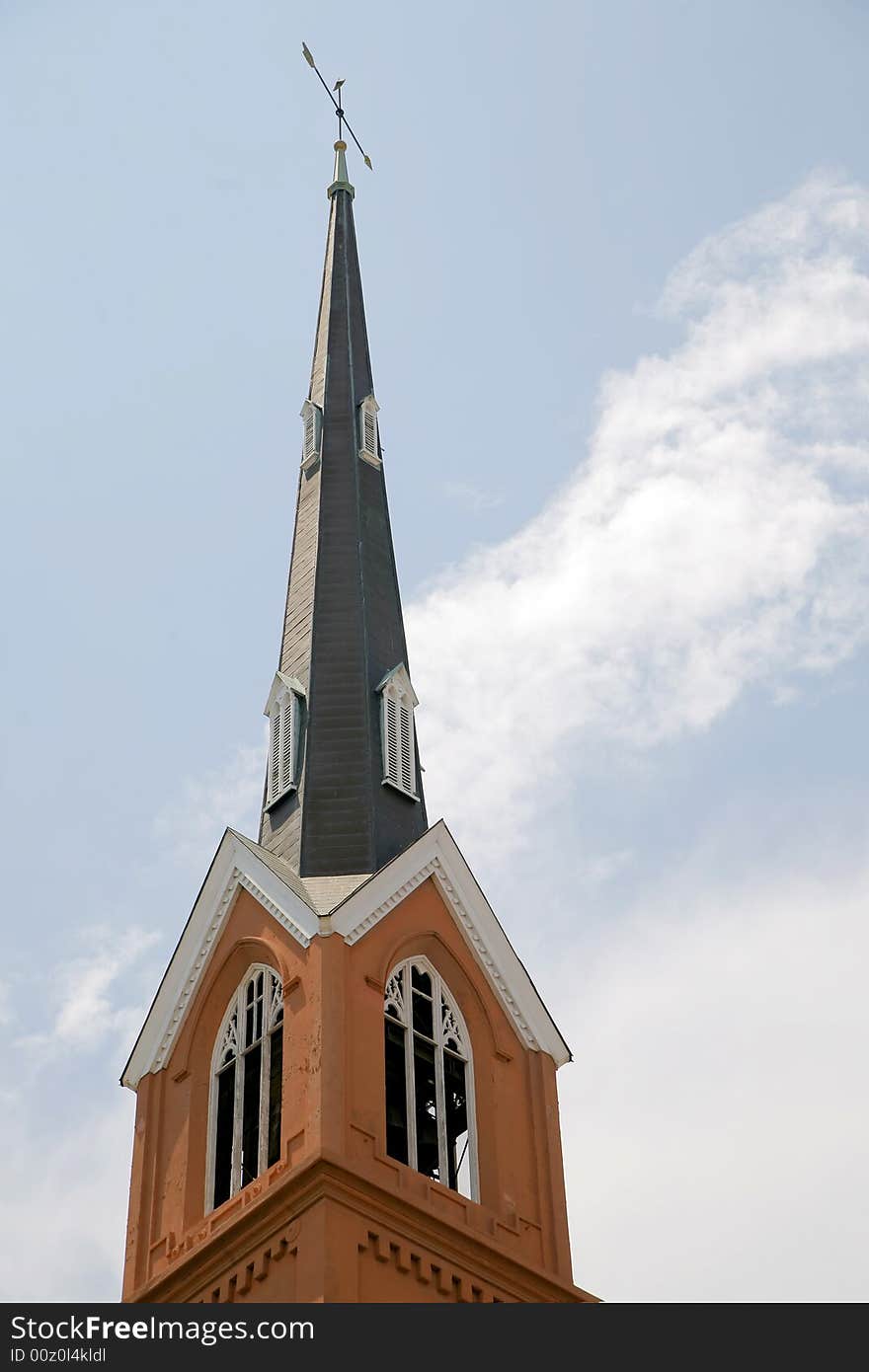 Looking up at an old brick church steeple. Looking up at an old brick church steeple