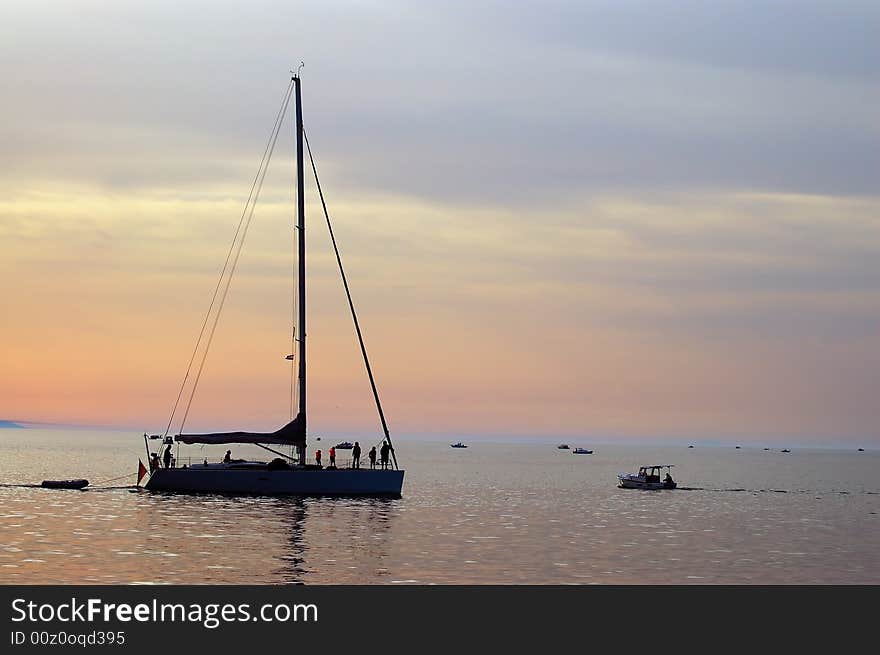 Silhouette of yacht coming into harbour