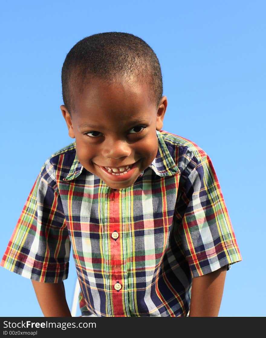 Boy smiling on a blue background. Boy smiling on a blue background