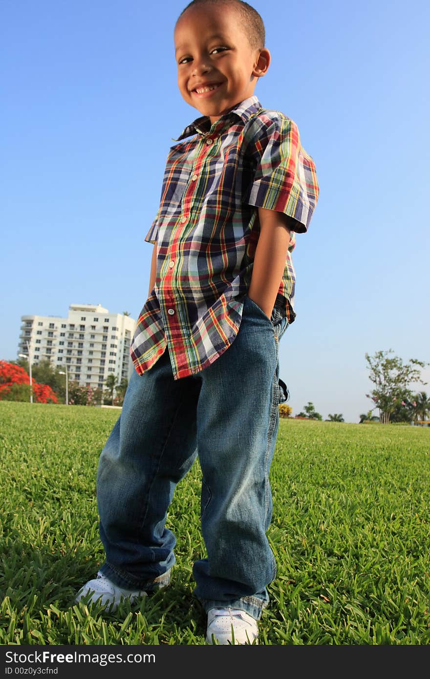 Young fashionable child posing on the grass. Young fashionable child posing on the grass.