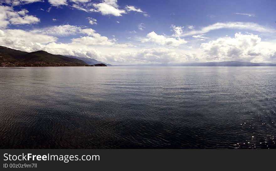 Lake Ohrid is the deepest lake of the Balkans, with a maximum depth of 288 m (940 ft) and a mean depth of 155 m (508 ft). It covers an area of 358 km² (138 sq mi), containing an estimated 55.4 km³ of water. It is 30.4 km long by 14.8 km wide at its maximum extent with a shoreline length of 87.53 km, shared between the Republic of Macedonia (56.02 km) and Albania (31.51 km). Lake Ohrid is the deepest lake of the Balkans, with a maximum depth of 288 m (940 ft) and a mean depth of 155 m (508 ft). It covers an area of 358 km² (138 sq mi), containing an estimated 55.4 km³ of water. It is 30.4 km long by 14.8 km wide at its maximum extent with a shoreline length of 87.53 km, shared between the Republic of Macedonia (56.02 km) and Albania (31.51 km).