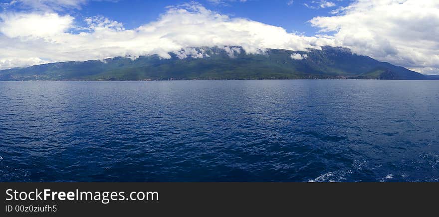 The lake drains an area of around 2600 km² and is fed primarily by underground springs on the eastern shore (about 50% of total inflow), with roughly 25% shares from rivers and direct precipitation. Over 20% of the lake's water comes from nearby Lake Prespa, about 10 km (6 miles) to the southeast and at 150 m higher altitude than Lake Ohrid. The water leaves Lake Prespa trickling through underground watercourses in the karstic landscape, where it is joined by mountain range precipitation and eventually emerges in numerous springs along the eastern shore and below the water surface of Lake Ohrid. The water leaves Lake Ohrid by evaporation (~40%) and through its only outlet, the Black Drin River, which flows in a northerly direction into Albania and thus to the Adriatic Sea. The relatively dry, Mediterranean climate and the small drainage basin of 2600 km² (catchment/lake surface ratio of ~7) of Lake Ohrid results in a long hydraulic residence time scale of ~70 yr. The lake drains an area of around 2600 km² and is fed primarily by underground springs on the eastern shore (about 50% of total inflow), with roughly 25% shares from rivers and direct precipitation. Over 20% of the lake's water comes from nearby Lake Prespa, about 10 km (6 miles) to the southeast and at 150 m higher altitude than Lake Ohrid. The water leaves Lake Prespa trickling through underground watercourses in the karstic landscape, where it is joined by mountain range precipitation and eventually emerges in numerous springs along the eastern shore and below the water surface of Lake Ohrid. The water leaves Lake Ohrid by evaporation (~40%) and through its only outlet, the Black Drin River, which flows in a northerly direction into Albania and thus to the Adriatic Sea. The relatively dry, Mediterranean climate and the small drainage basin of 2600 km² (catchment/lake surface ratio of ~7) of Lake Ohrid results in a long hydraulic residence time scale of ~70 yr.