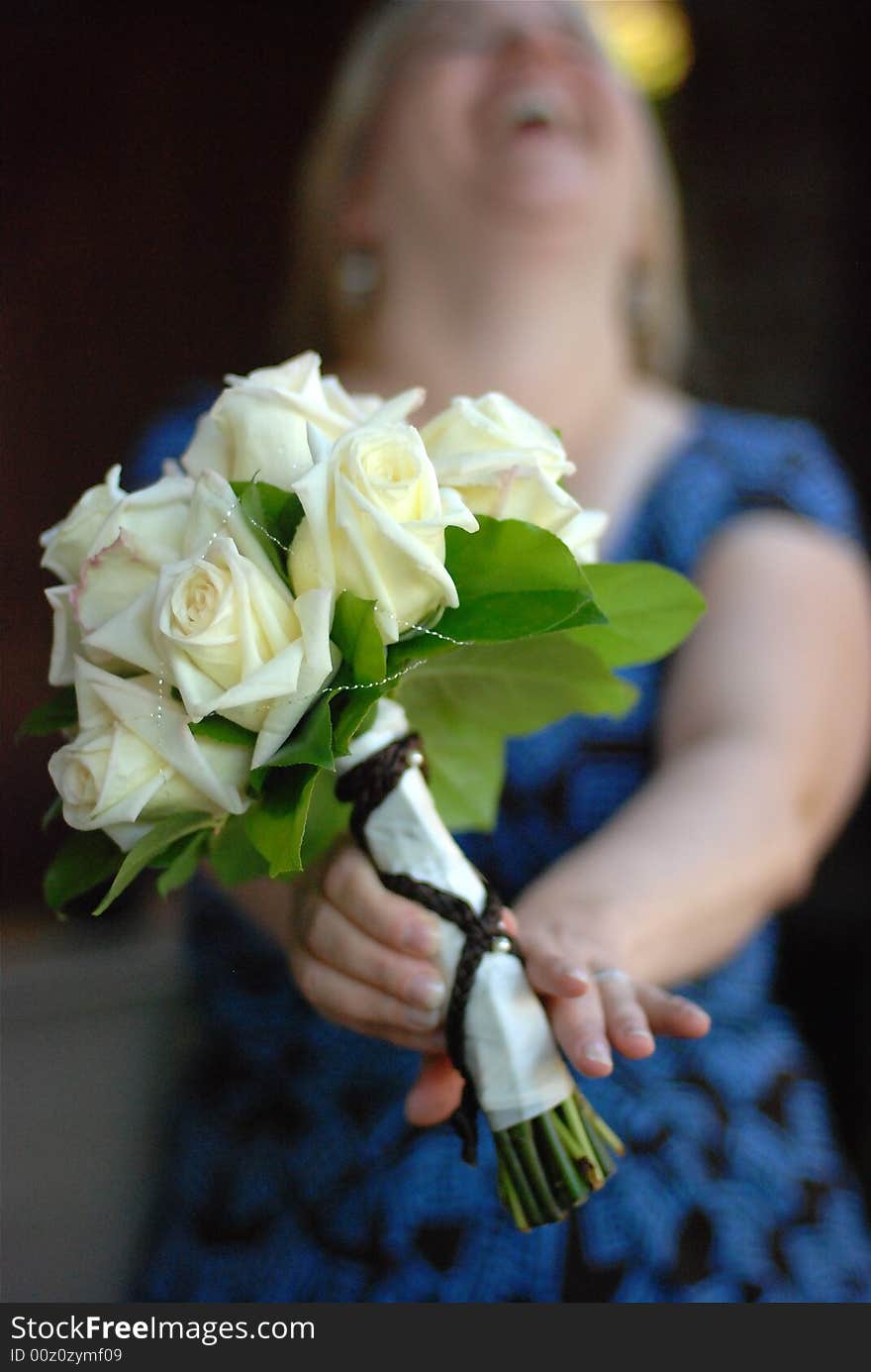 Woman holding a bouquet as she is laughing. Woman holding a bouquet as she is laughing