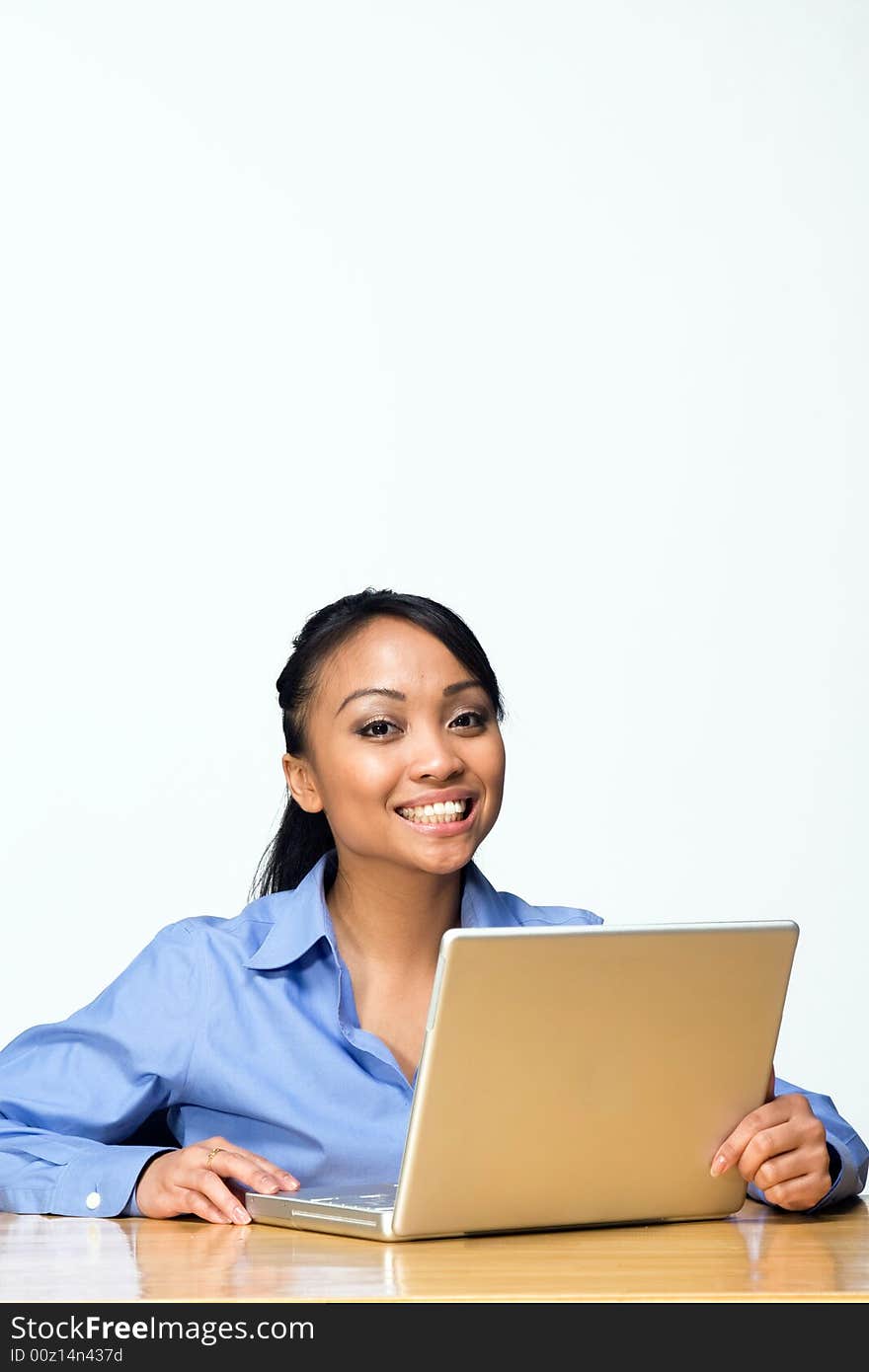 Female student smiles while looking at the camera. Vertically framed photograph. Female student smiles while looking at the camera. Vertically framed photograph