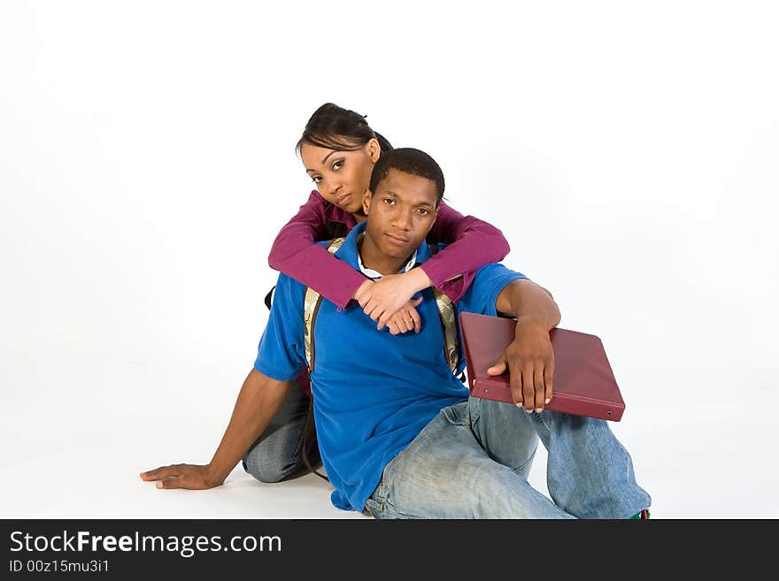 Two students looking at the camera while she has her arms around his neck. Horizontally framed photograph. Two students looking at the camera while she has her arms around his neck. Horizontally framed photograph