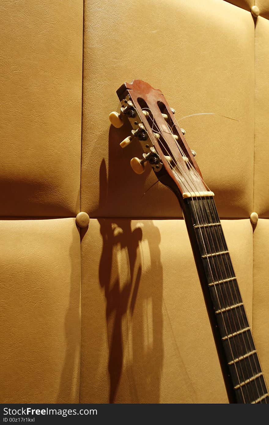 An acoustic guitar with a simple background at night