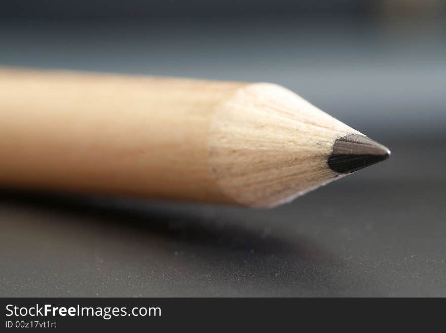 A pencil with a simple black color background. A pencil with a simple black color background