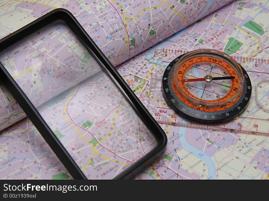 A compass and magnifying glass on the map.