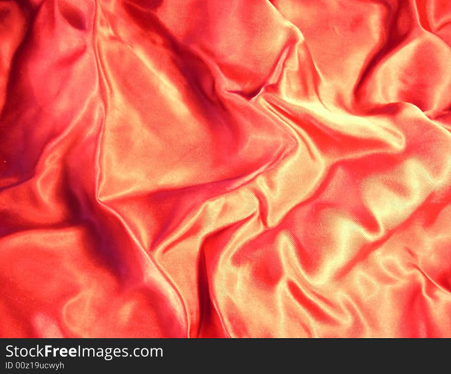 A photograph of red shining material. Fine texture. A photograph of red shining material. Fine texture