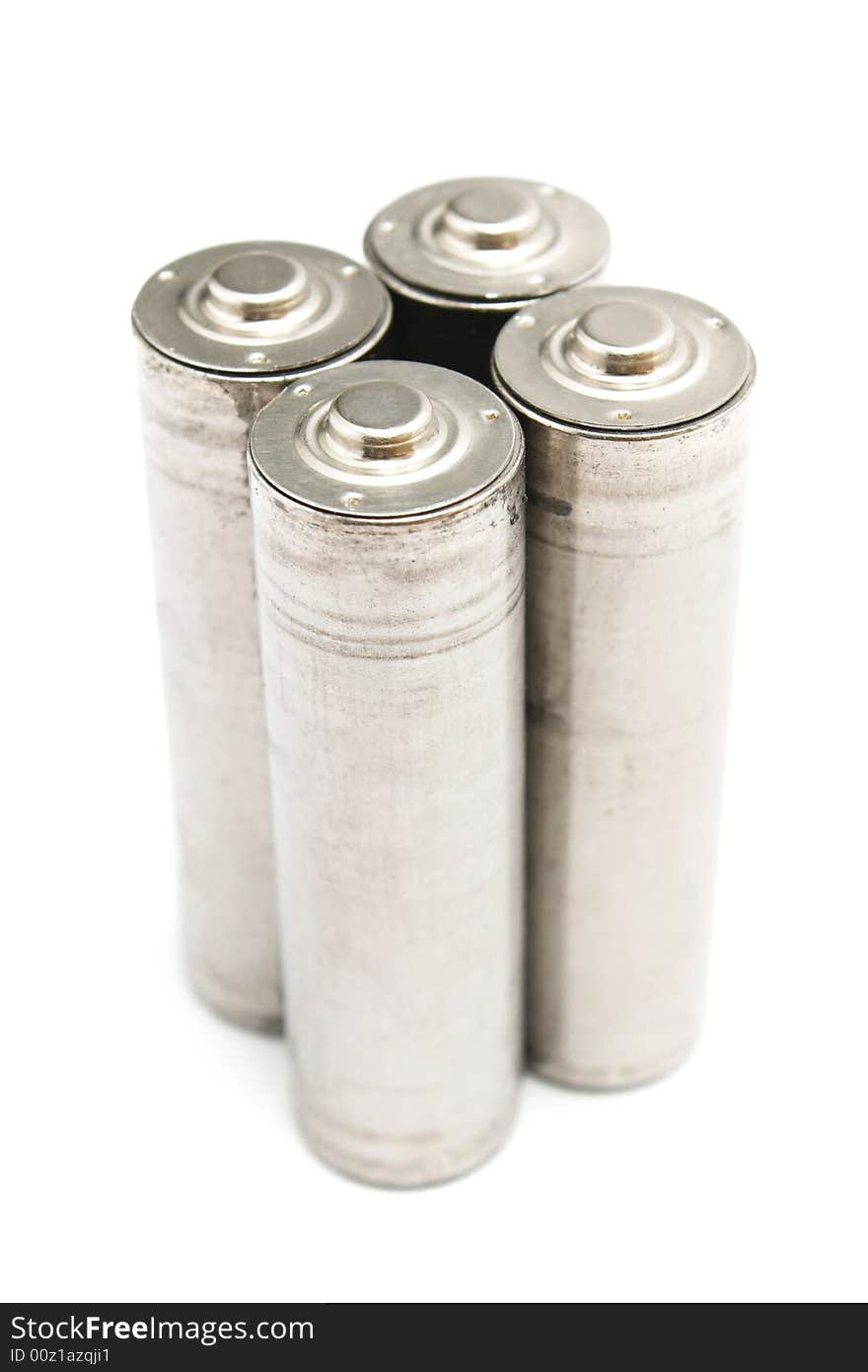 Four AA size batteries standing on white background. Four AA size batteries standing on white background.