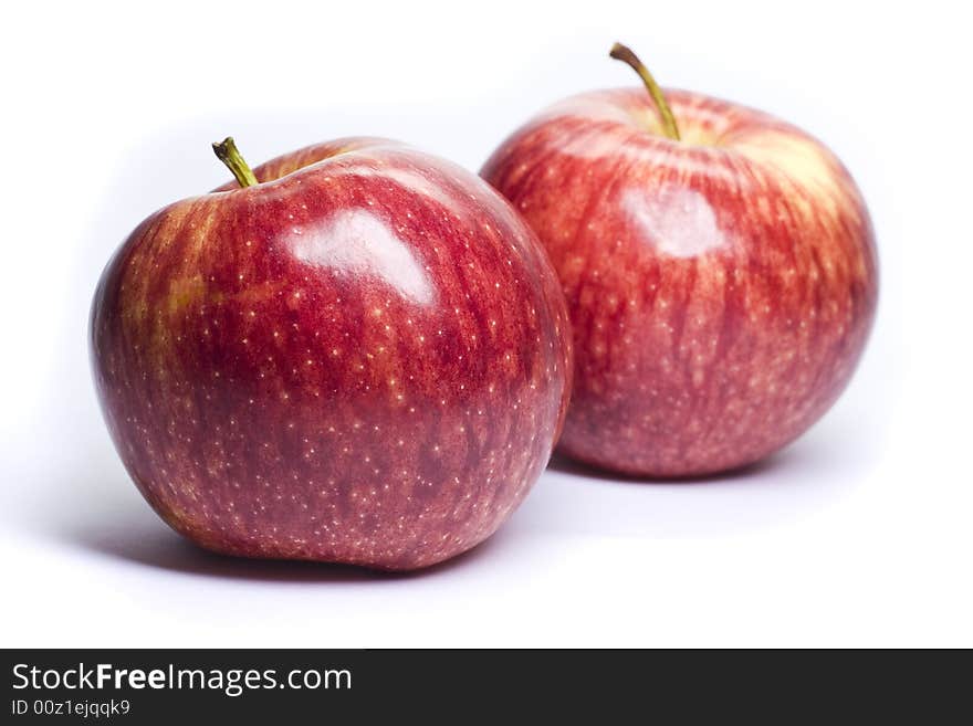 Ripe red apples on a white background