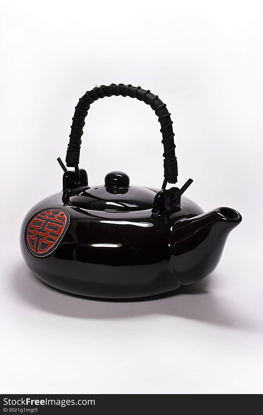 Black clay teapot from China on a white background