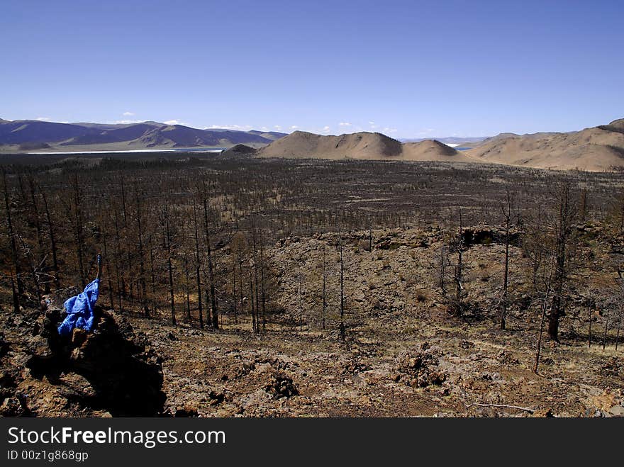 Lava fields and extinct volcanoes scattered across flat volcanic plains around Terkh Lake in central Mongolia. Lava fields and extinct volcanoes scattered across flat volcanic plains around Terkh Lake in central Mongolia