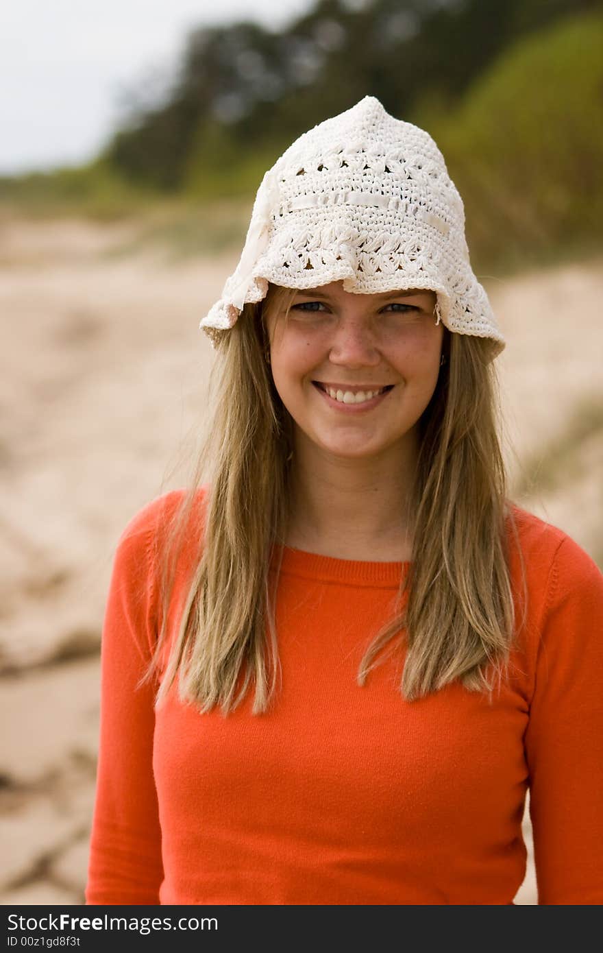 Beautiful young girl standing on the sea beach. Beautiful young girl standing on the sea beach