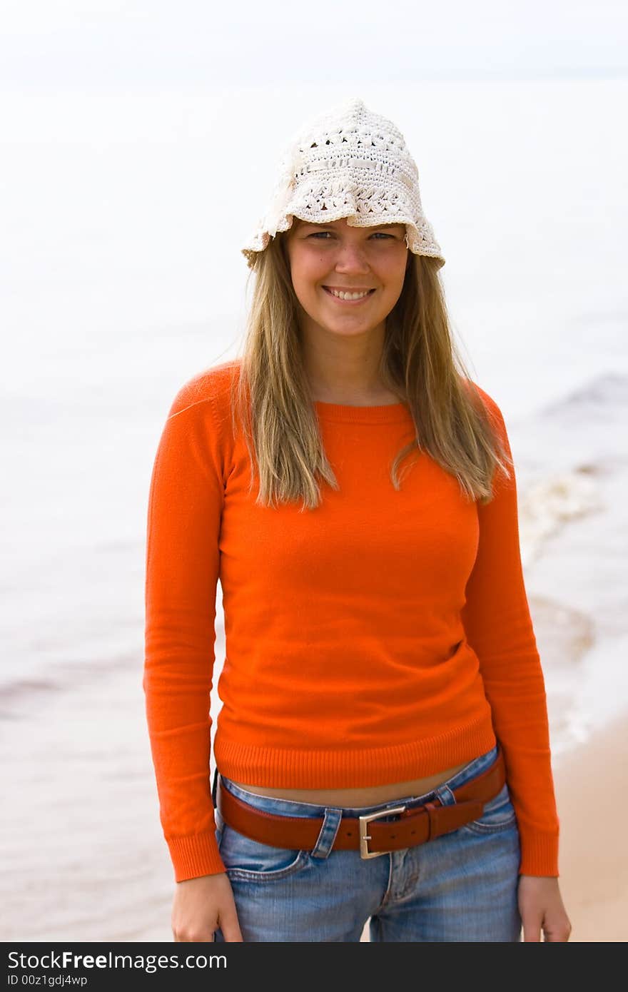 Young nice girl standing on the beach