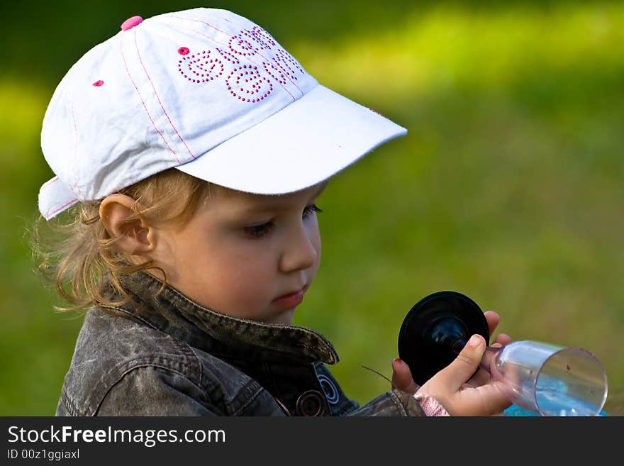 Young girl playing with the cup