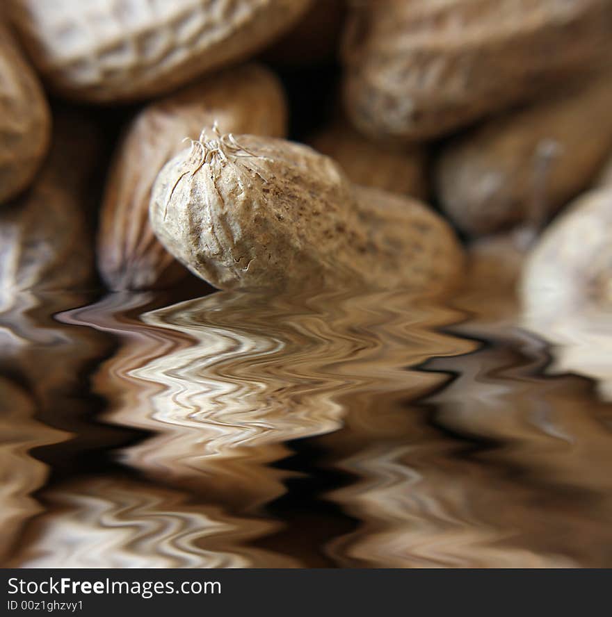 A close up of various shapes and sizes of peanuts in their shells