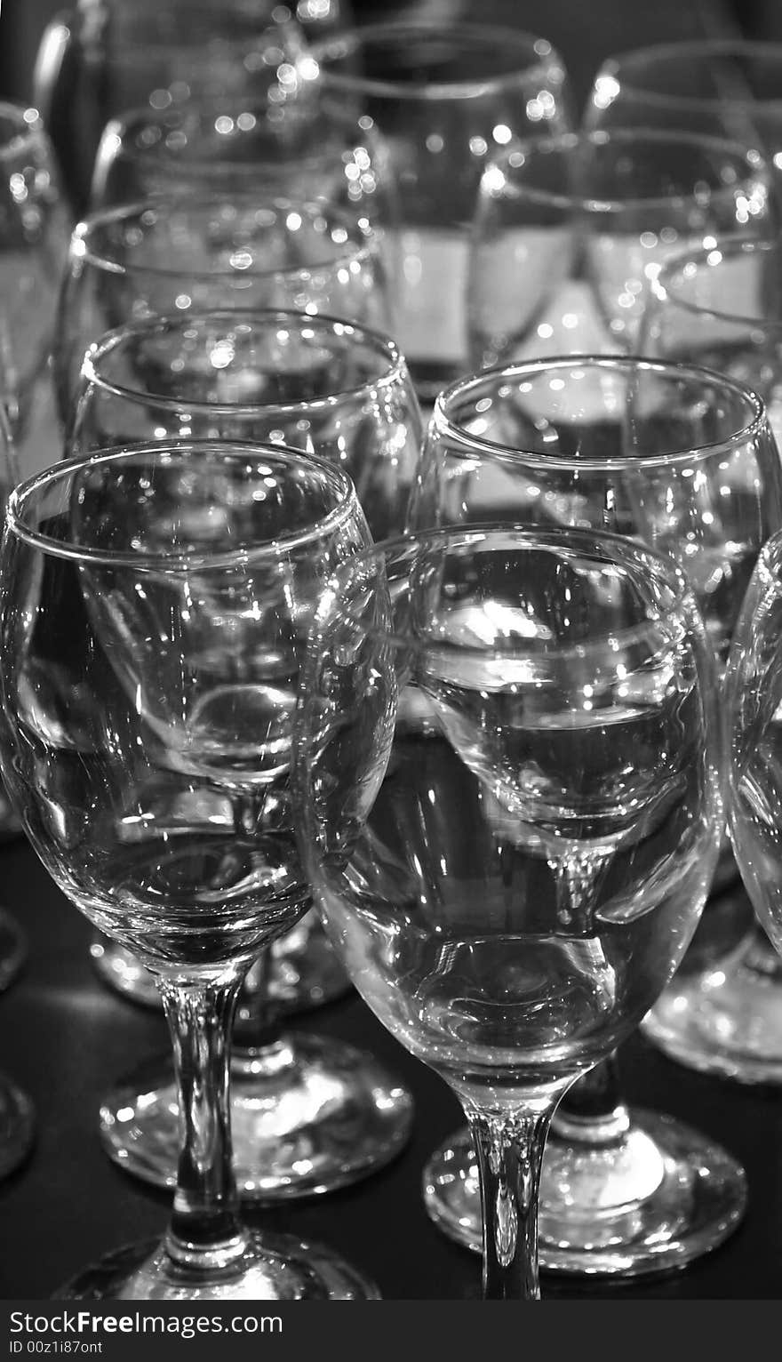 A lot of glasses in readyness for a party in black and white. A lot of glasses in readyness for a party in black and white