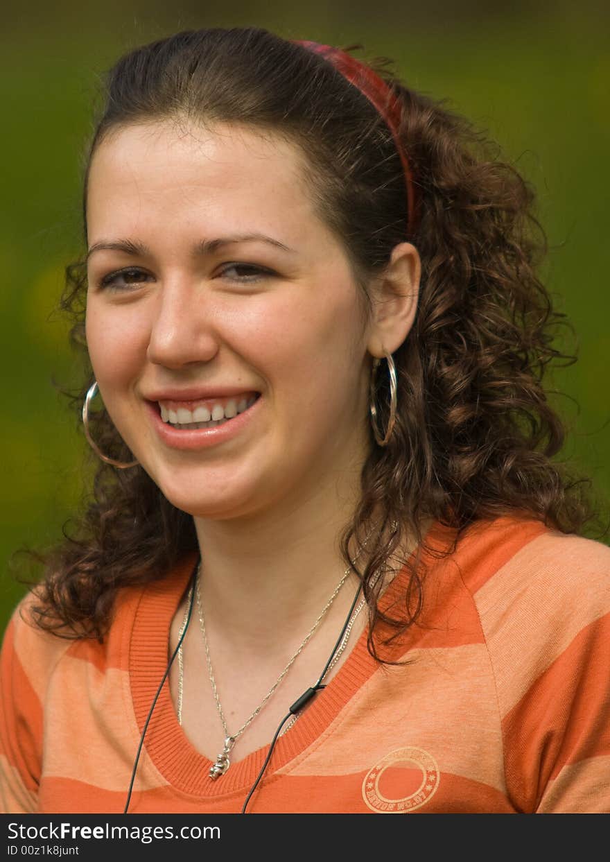 Smiling Girl Outdoors on Green Background