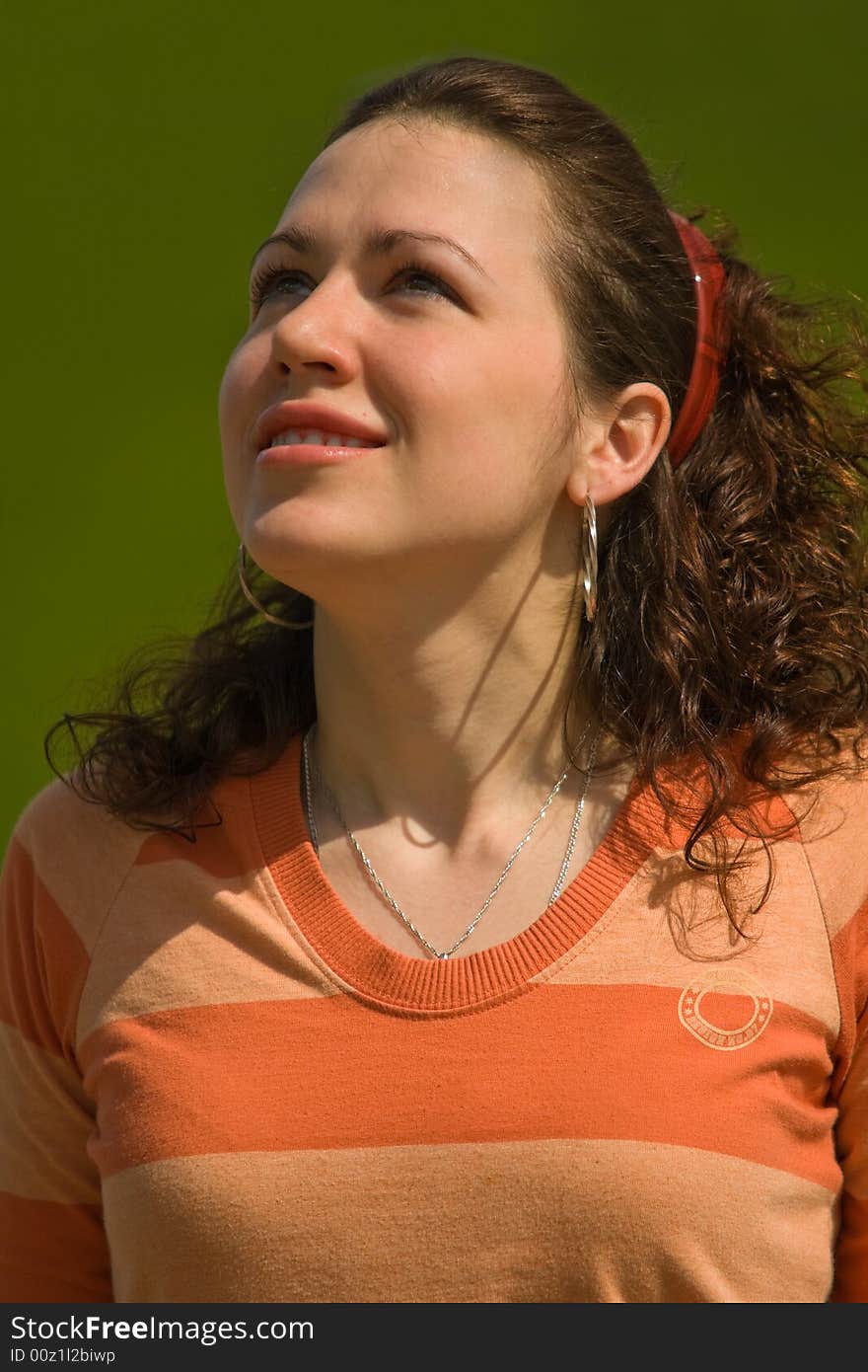 Smiling Girl Outdoors on Green Background