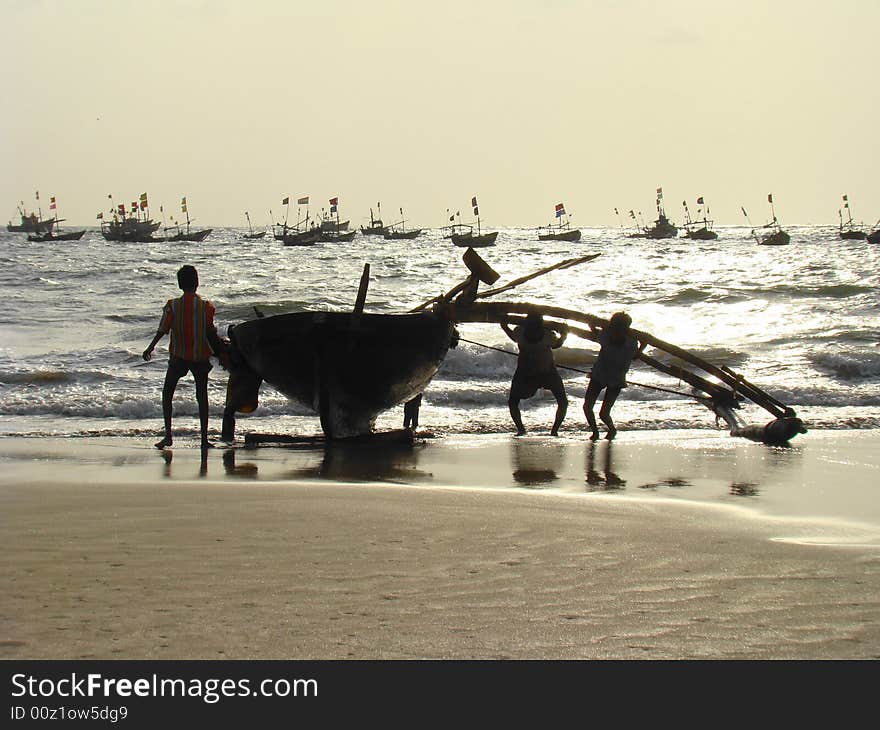 Fishermen bringing the boats back to the shore. Fishermen bringing the boats back to the shore.