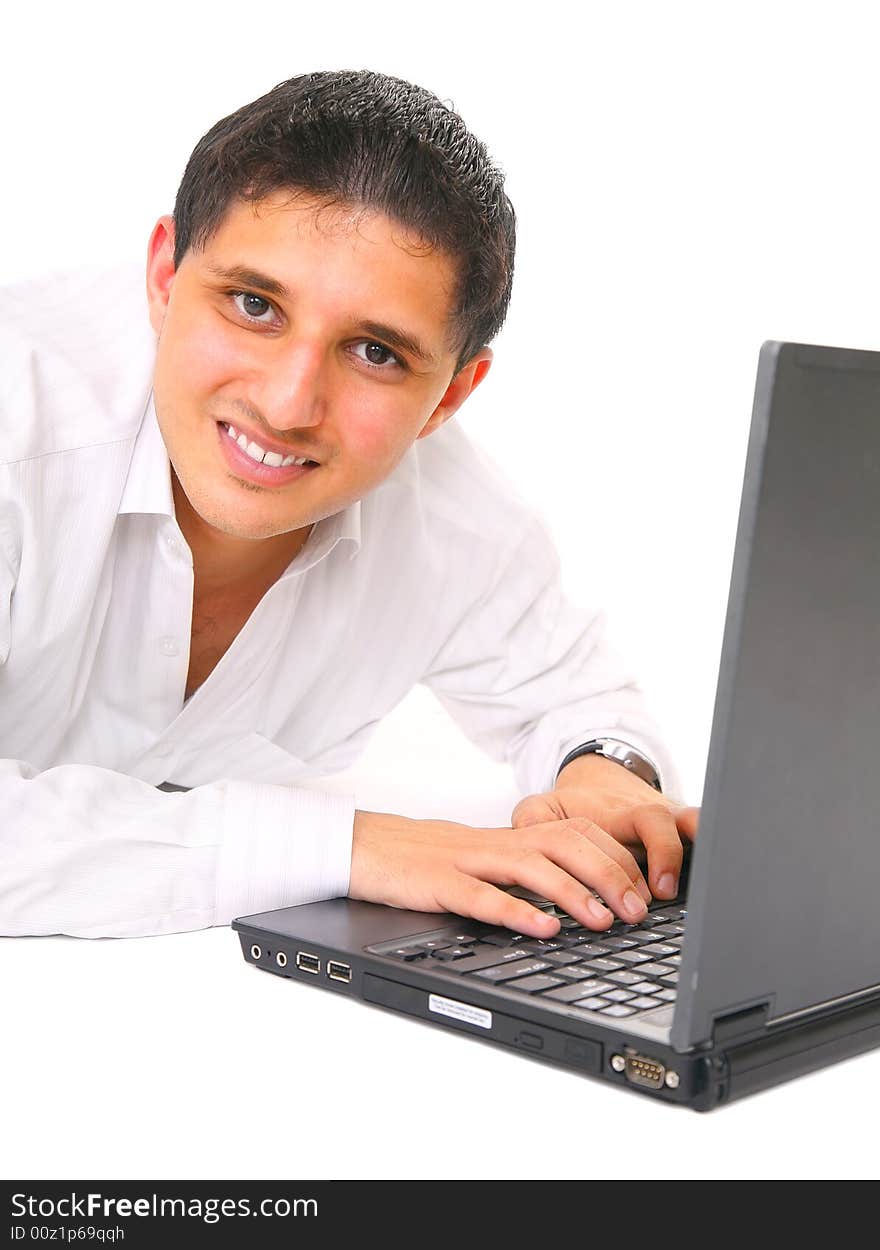 Smiling young man typing on laptop. isolated on white background. Smiling young man typing on laptop. isolated on white background