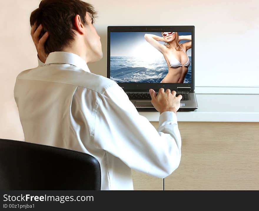 a man looking a image of a beautiful woman on a desktop