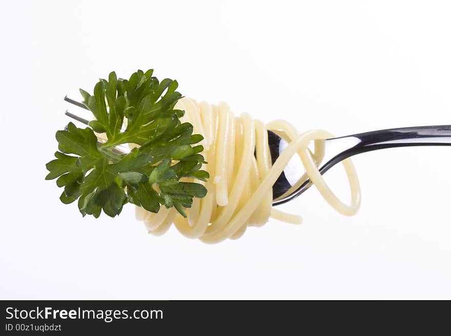 Spaghetti and parsley on a fork