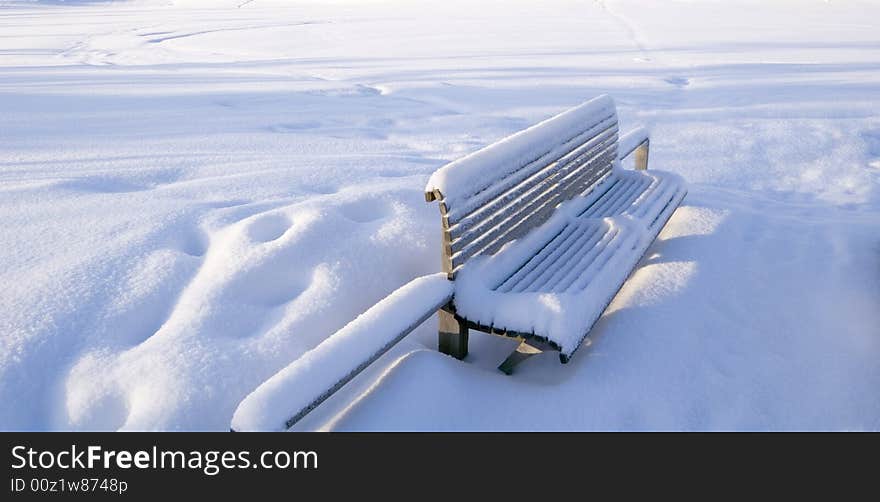 Outdoor snow covered bench