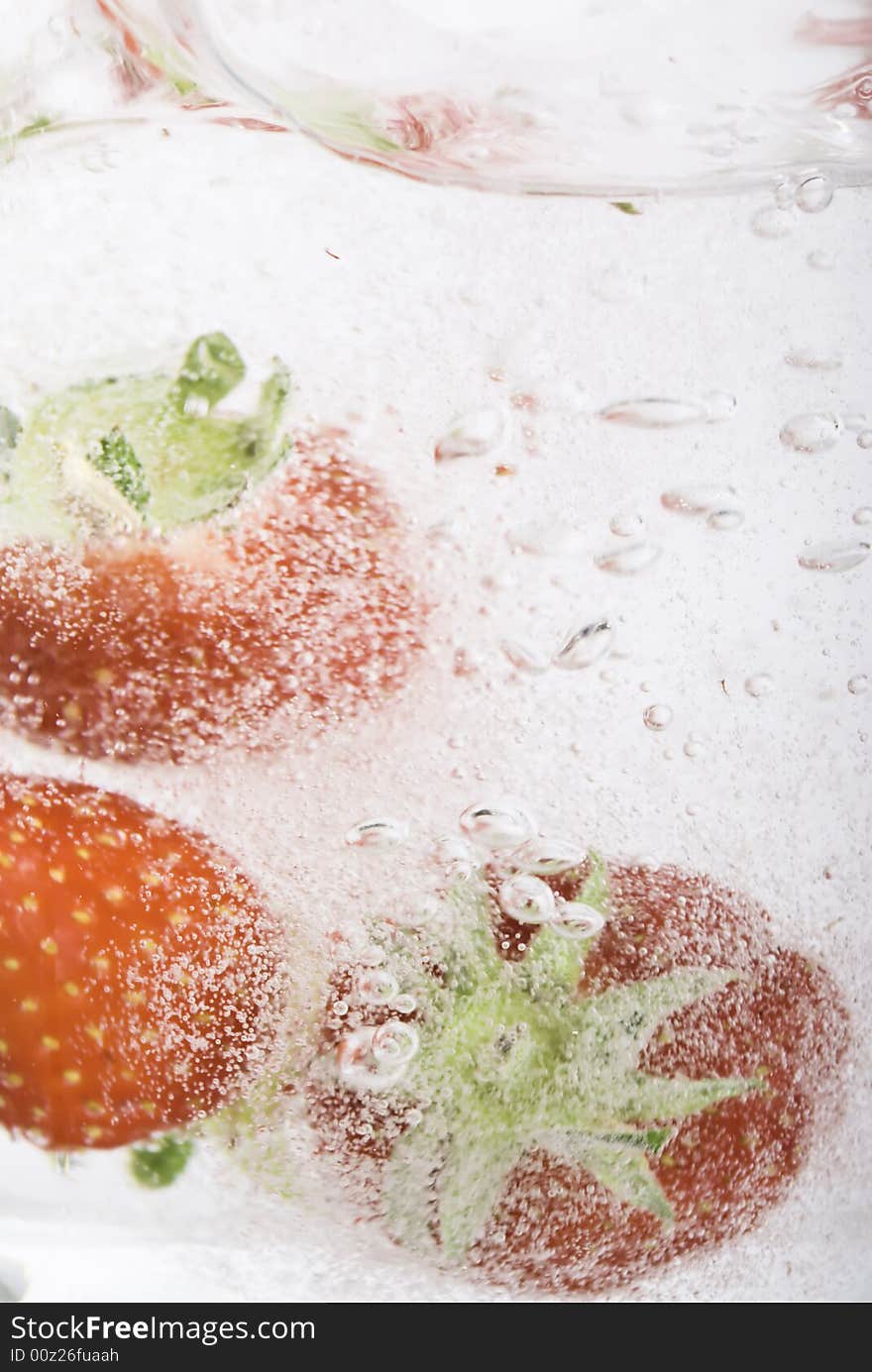 Close up of strawberries splashing in water splash and bubbles. Close up of strawberries splashing in water splash and bubbles