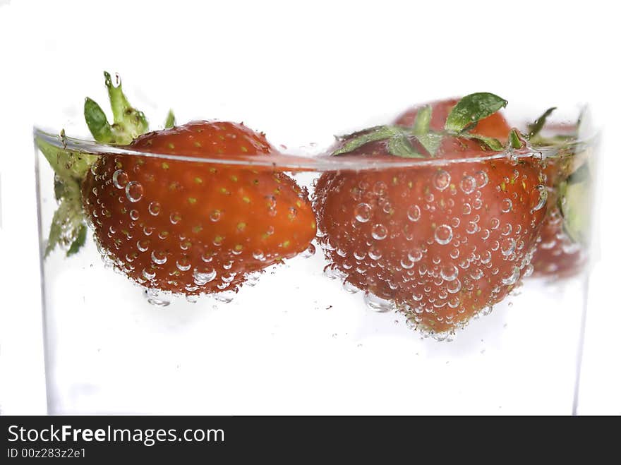 Close up of strawberries splashing in water splash and bubbles. Close up of strawberries splashing in water splash and bubbles