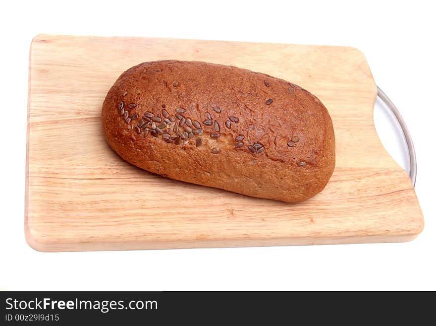 Bread with seeds on wooden plate. Bread with seeds on wooden plate.