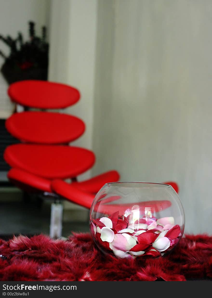 Vase of rose petals on a table in a modern house - home decors.