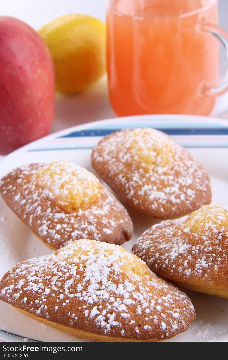 Doughnuts with fruits and powdered on the plate