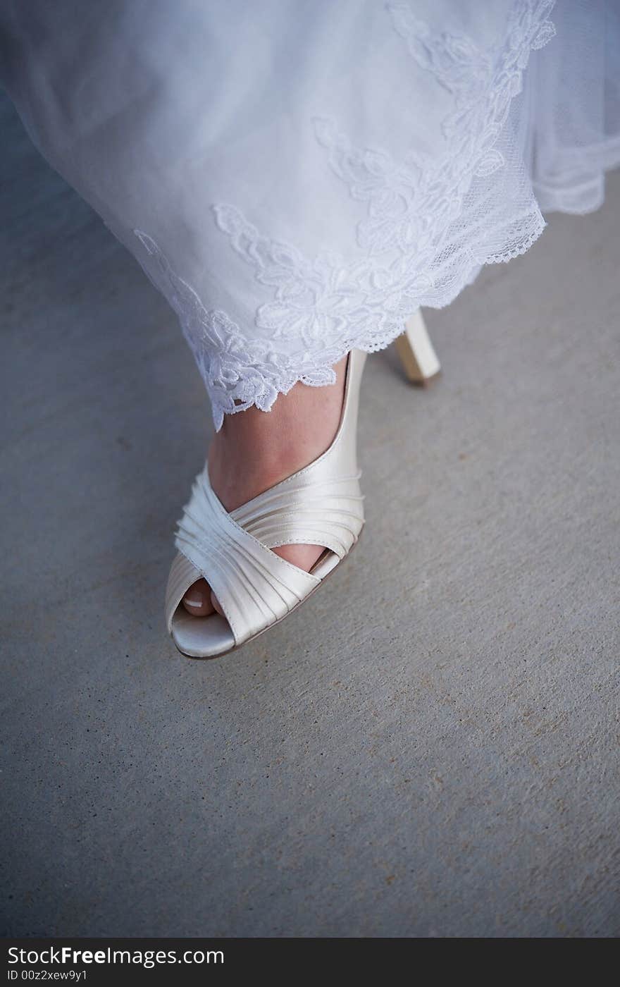 Bride s formal shoe showing from underneath gown