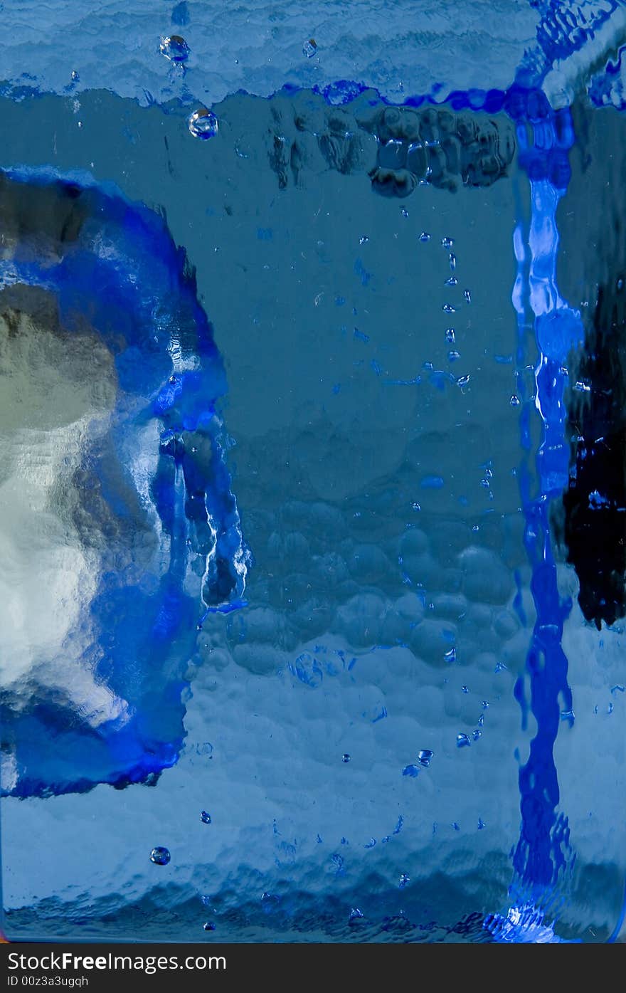 Human face in blue glass block. Human face in blue glass block