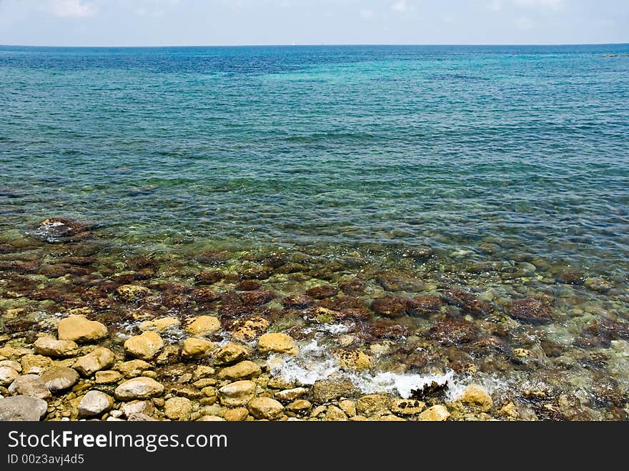 A coastline with stones in the summer