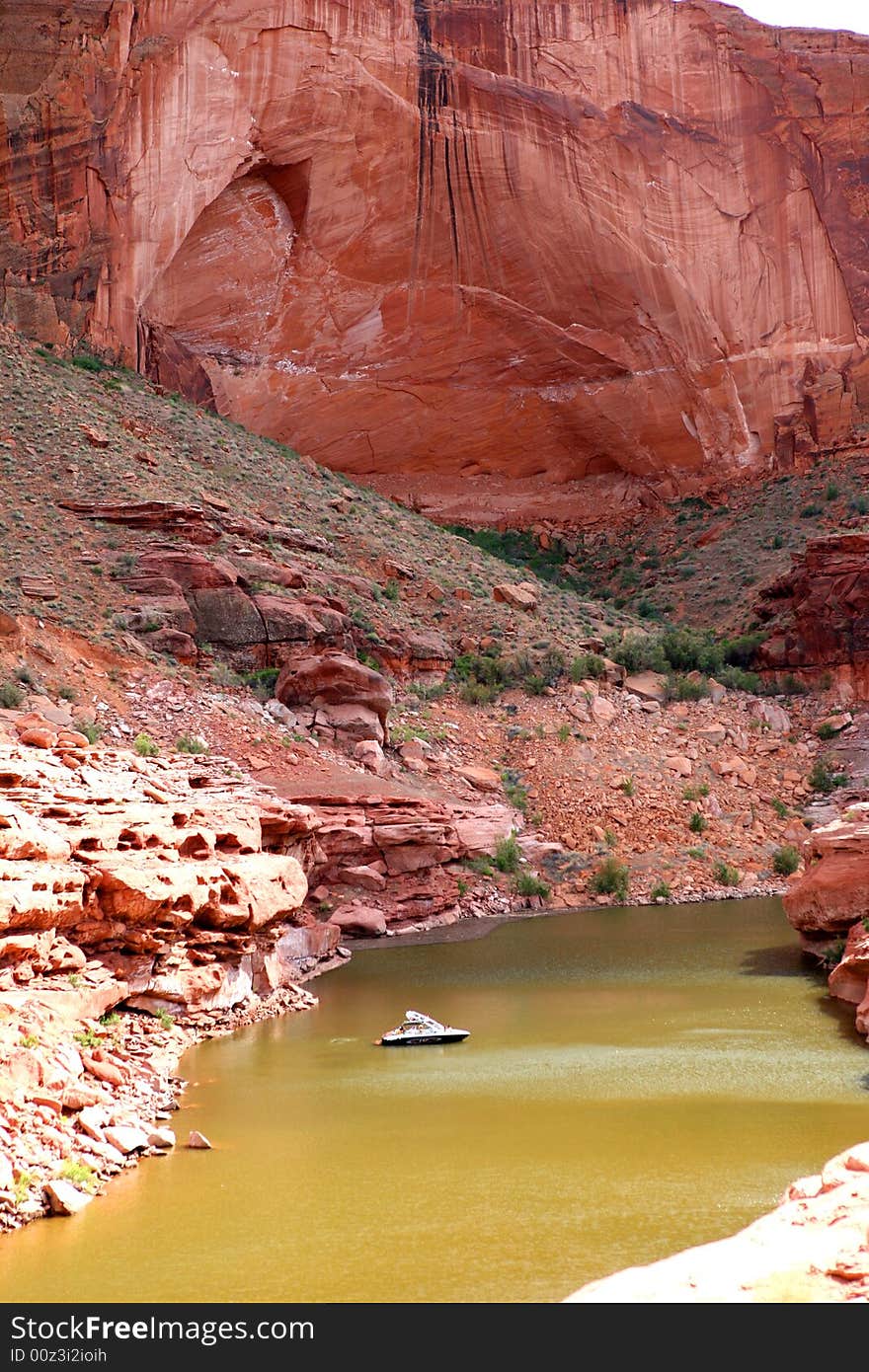 A boat floats in a deep canyon at Lake Powell, Utah. A boat floats in a deep canyon at Lake Powell, Utah.